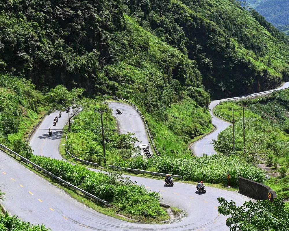 Motorbike riders crossing Tham Ma Pass in Ha Giang